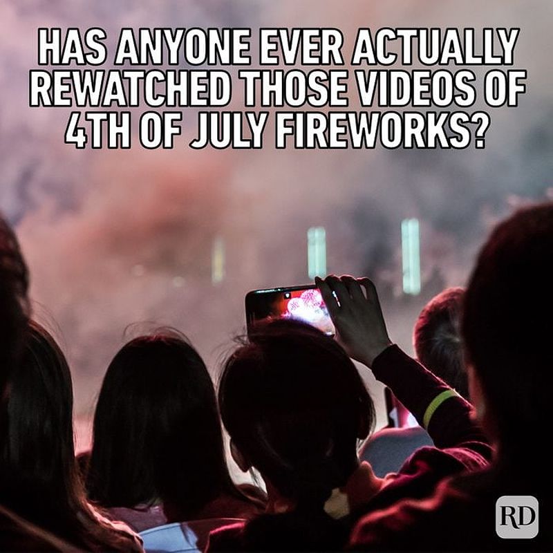 Group of people watching and recording fireworks